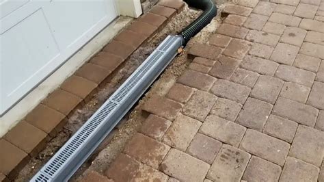 installing channel drain along patio.